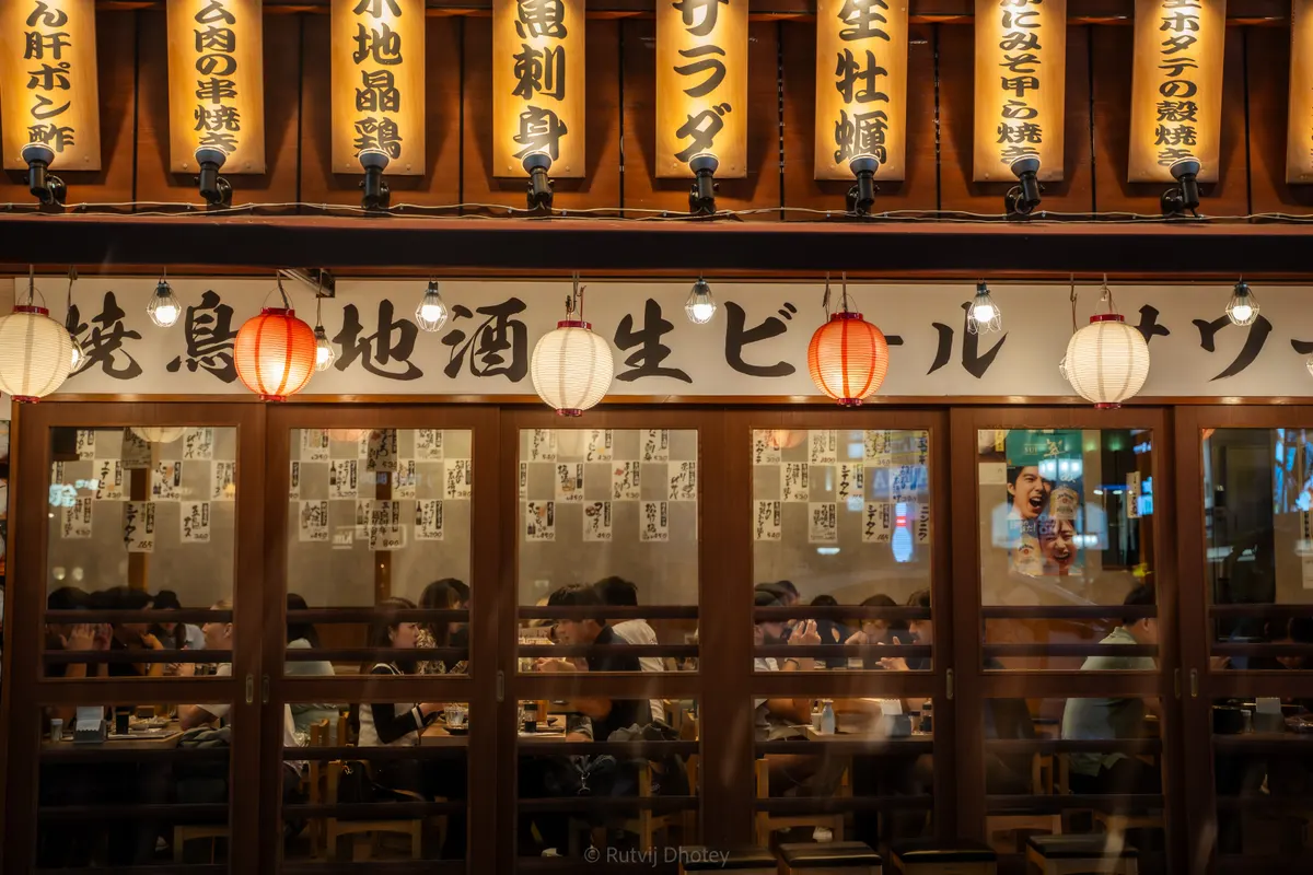 Red paper lanterns strung outside an izakaya