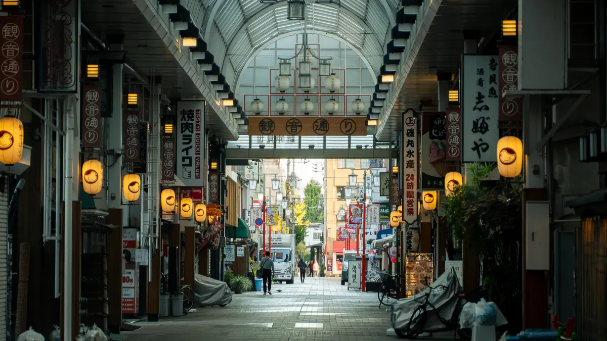 The length of a covered shopping arcade, lit and almost empty